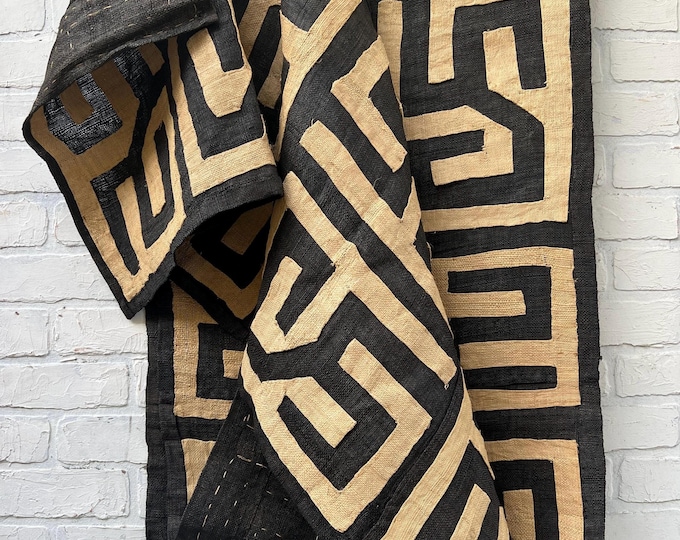 Hand made tapestry kuba cloth with hand stitched geometric designs of black and natural raffia. Abstract art piece for wall decor.