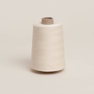 Raw unbleached cotton overlocker spool on cardboard cone with paper wrap. 100% Plastic free and biodegradable image 1