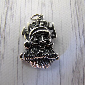 The Joy of Santa Charm,   is  jolly ole St Nick's headshot wishing you a Merry Christmas in a sterling silver charms alone or on a bracelet.