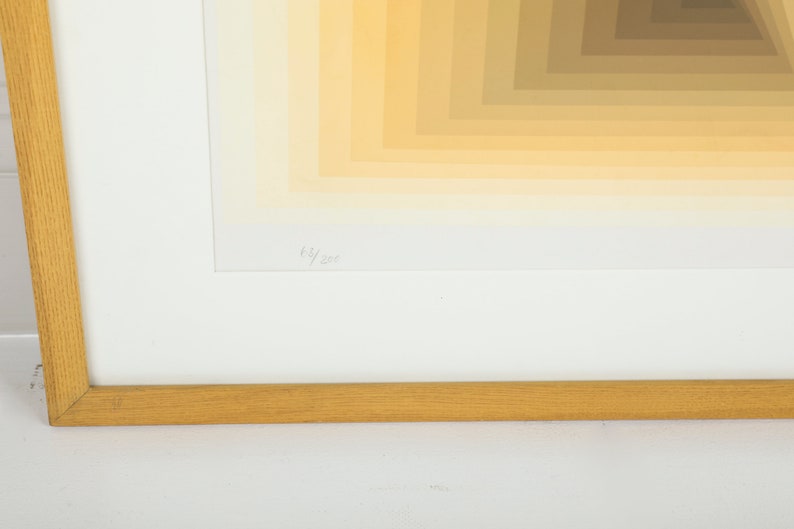 May include: A framed print with a geometric pattern of yellow and brown squares. The print is numbered 63/200.