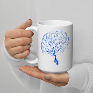May include: White ceramic mug with a blue watercolor illustration of a brain. The illustration is stylized to look like a network of veins.