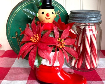 Santa boot & snowman poinsettia arrangement