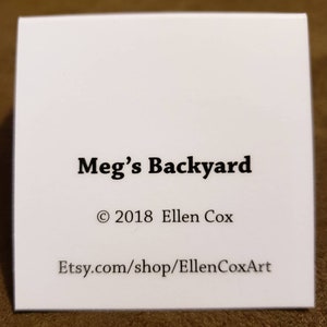 May include: White card with black text that reads "Meg's Backyard", "&copy; 2018 Ellen Cox", and "Etsy.com/shop/EllenCoxArt".