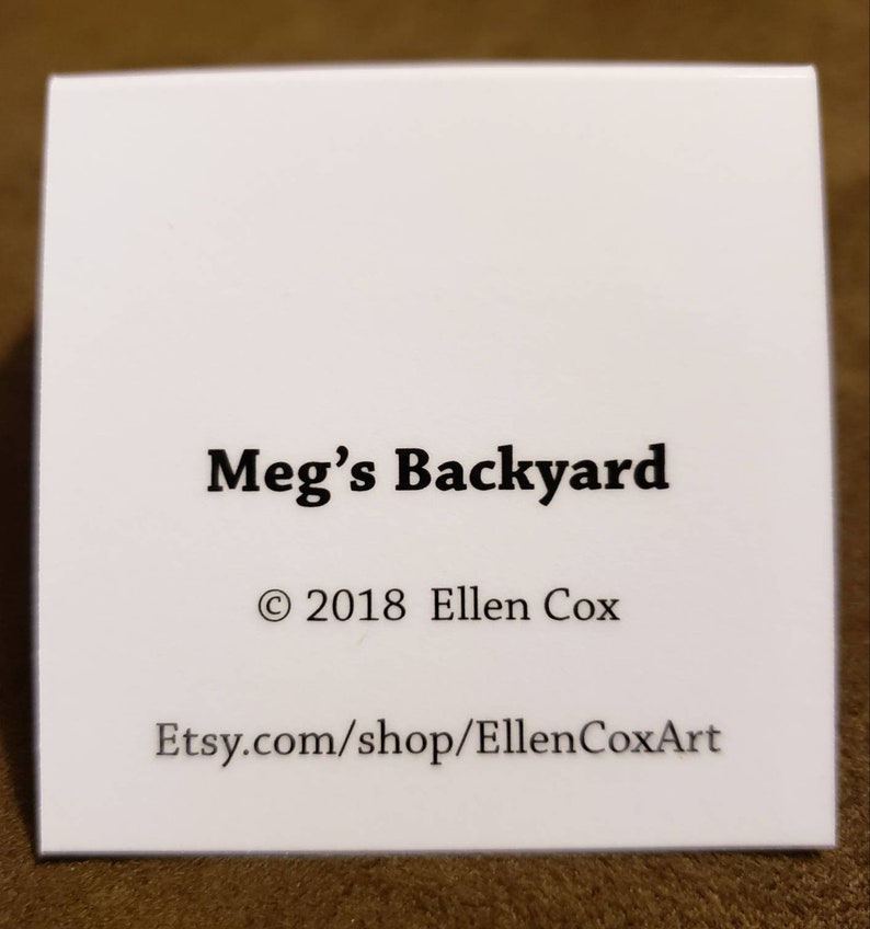May include: White card with black text that reads "Meg's Backyard", "&copy; 2018 Ellen Cox", and "Etsy.com/shop/EllenCoxArt".