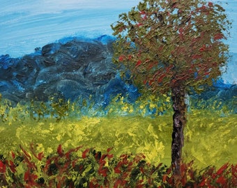 May include: A painting of a landscape with a single tree in the foreground. The tree has a dark brown trunk and green and red leaves. The background is a blue sky with a dark blue mountain range in the distance. The ground is a mix of green and yellow.