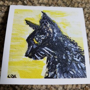 May include: A painting of a black cat with yellow eyes, set against a yellow background. The cat is looking to the left of the image. The painting is signed "COX" in the bottom left corner.