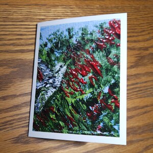 May include: Abstract painting on canvas with a mix of red, green, and blue colors. The painting has a textured look, with thick brushstrokes and a swirling pattern.