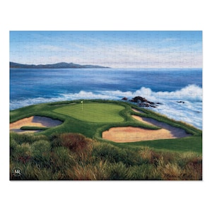 May include: A jigsaw puzzle featuring a golf course scene with a green, sand traps, and ocean waves. The puzzle has a blue sky and a green golf course with a yellow flag. The puzzle is a landscape scene.
