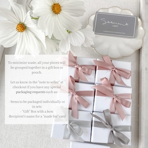 May include: Multiple small white gift boxes with pink and gray ribbon bows. The boxes are arranged in a grid pattern. The text "To minimize waste, all your pieces will be grouped together in a gift box or pouch. Let us know in the 'note to seller' at checkout if you have any special packaging requests such as: - Items to be packaged individually or in sets - 'Gift' Box with a bow - Recipient's name for a 'made for' card" is visible in the image.
