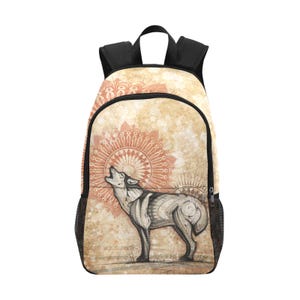 May include: A black backpack with a design of a wolf howling at a mandala. The mandala is in shades of orange and brown on a beige background.