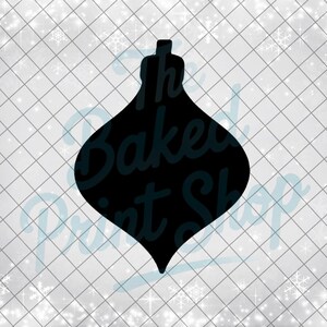 May include: Black silhouette of a Christmas ornament with a rounded body and a small, cylindrical top. The ornament shape is set against a white background with a grid pattern and snowflake accents. The text "The Baked Print Shop" is visible.