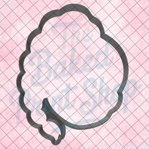 May include: A dark gray cookie cutter in the shape of a cloud with a small, stylized leaf. The cutter is on a pink background with a grid pattern. The text "The Baked Print Shop" is visible.