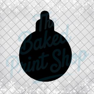 May include: Black Christmas ornament silhouette with the text "The Baked Print Shop" in a cursive font. The ornament is on a white background with a grid pattern and snowflake accents.