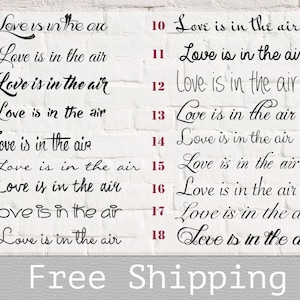 May include: A white brick wall with 18 black and white signs that say "Love is in the air" with a number next to each sign. The numbers range from 1 to 18. The text "Free Shipping" is at the bottom of the image.