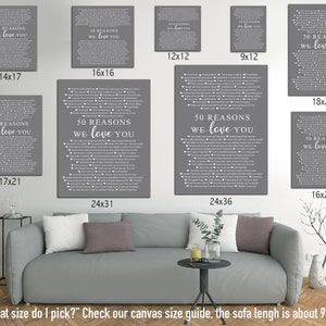 May include: A gray sofa with a green plant and a glass of water on a table in front of it. The wall behind the sofa has several framed prints with the text "50 Reasons We Love You" in white on a gray background. The prints are available in various sizes, including 14x17, 16x16, 12x12, 9x12, 18x24, 17x21, 16x20, 24x31, and 24x36 inches.