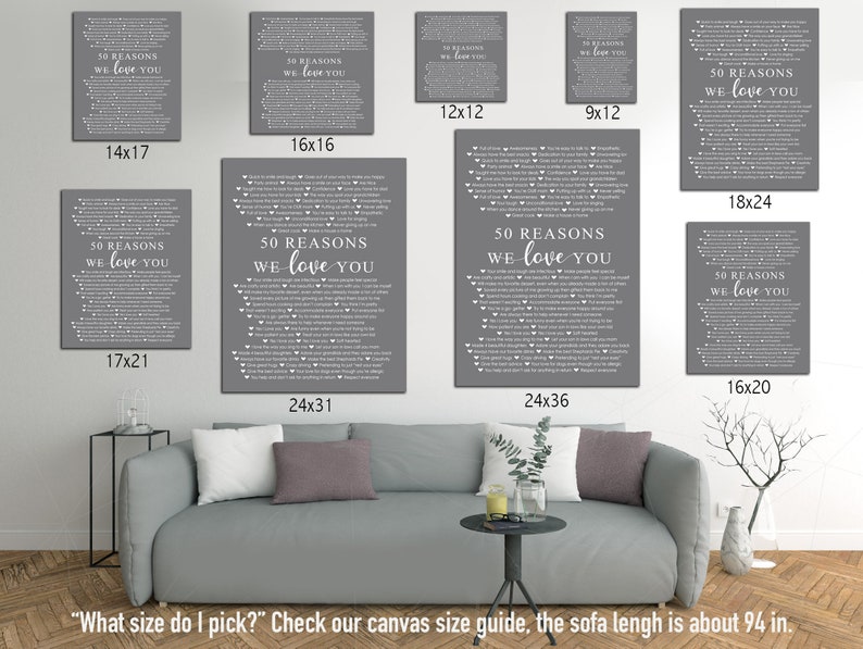 May include: A gray sofa with a green plant and a glass of water on a table in front of it. The wall behind the sofa has several framed prints with the text "50 Reasons We Love You" in white on a gray background. The prints are available in various sizes, including 14x17, 16x16, 12x12, 9x12, 18x24, 17x21, 16x20, 24x31, and 24x36 inches.