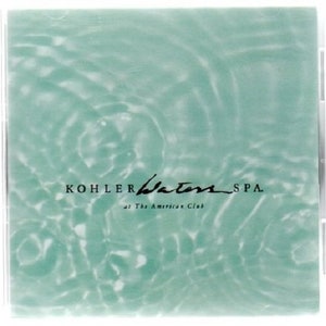 May include: A green and white abstract design with the text "KOHLER Waters SPA at The American Club" in black.