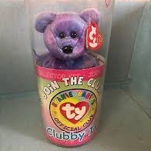 May include: Purple and blue tie-dye beanie baby in a clear plastic container with a pink and white label that says "Join the Club! Beanie Babies Official Club Clubby 1".