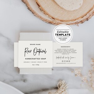 May include: White label with black text for a bar of Rose Oatmeal handcrafted soap. The label includes the brand name, ingredients, and social media icons. The soap is organic, vegan, and cruelty-free.