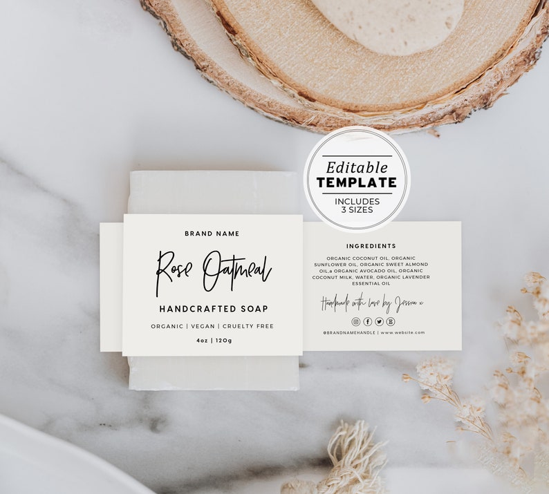 May include: White label with black text for a bar of Rose Oatmeal handcrafted soap. The label includes the brand name, ingredients, and social media icons. The soap is organic, vegan, and cruelty-free.