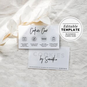 May include: A white business card with black text that reads "Cookies Cave" and includes instructions for storing cookies. The card also includes the text "Cookies by Samantha" and a website address.