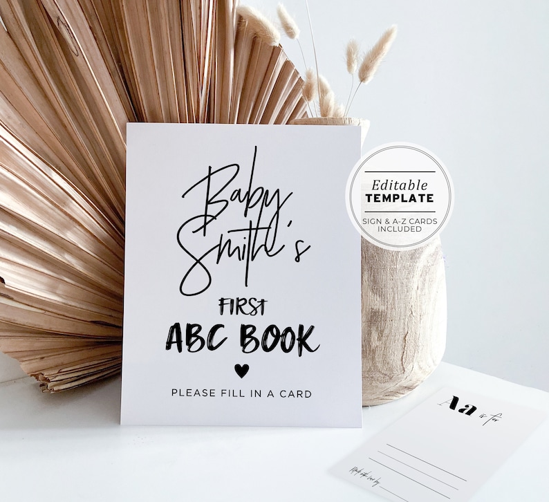 May include: A white sign with black text that reads "Baby Smith's First ABC Book" with a heart symbol. The sign also says "Please fill in a card". The sign is an editable template with sign and A-Z cards included.