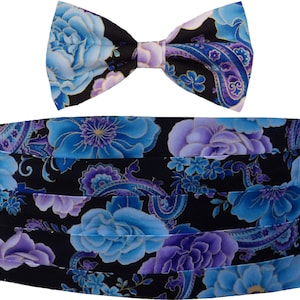 May include: A black bow tie and cummerbund set with a floral pattern featuring blue and purple flowers. The pattern is a paisley design.
