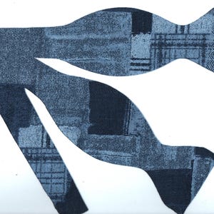 May include: A blue patterned bow tie with a unique design. The bow tie features a mix of dark and light blue fabrics with various textures, including a herringbone pattern. The bow tie is set against a white background.