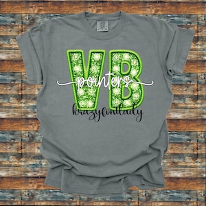 May include: A gray t-shirt with the text "VB pointers krazyfontlady" in green and white. The letters "VB" are outlined in green with a light green fill and small white circles. The text "pointers" is in a cursive font.