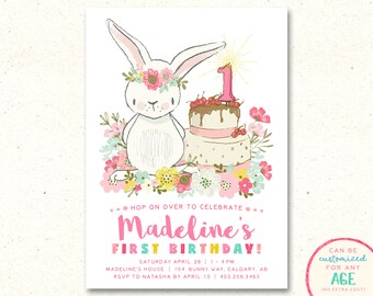 Puede incluir: Una invitación de cumpleaños rosa y blanca con un conejito blanco que lleva una corona de flores y un pastel rosa y blanco con glaseado de chocolate y una vela con el número uno. El texto de la invitación dice "Hop on over to celebrate Madeline's First Birthday!" con la fecha, la hora, la ubicación y la información de RSVP.
