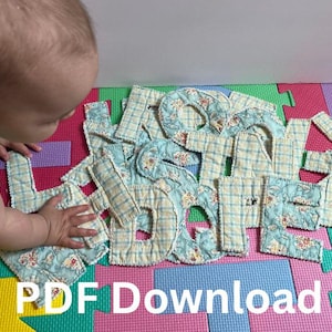 May include: A collection of fabric letters in a floral and plaid pattern, with the text "PDF Download" at the bottom. The letters are arranged on a colorful foam play mat.