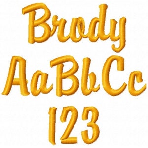 May include: Gold embroidered letters and numbers on a white background. The word "Brody" is displayed in cursive, along with the letters Aa, Bb, and Cc, and the numbers 123.