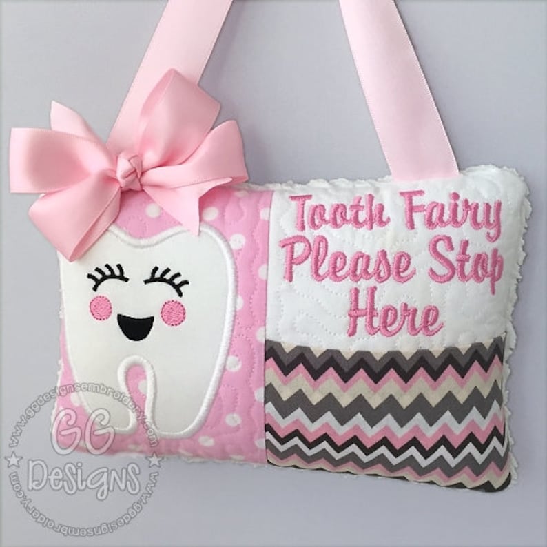 May include: Pink and white tooth fairy pillow with a smiling tooth and the text "Tooth Fairy Please Stop Here".