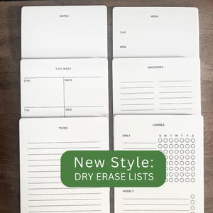 May include: Set of eight white dry erase boards with black text and lines. The boards include sections for notes, menu, groceries, chores, this week, to do, daily, and weekly.