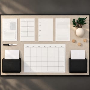 May include: A large rectangular wall-mounted magnetic board with a black frame, featuring a white monthly calendar, four smaller white planners labeled Chores, This Week, Menu, and To Do, two black storage pockets, a black marker, and a small vase.