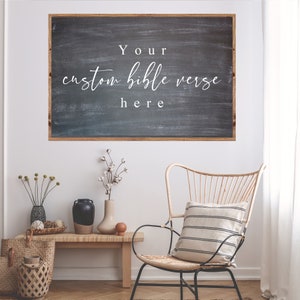 May include: A black chalkboard with a wooden frame hangs on a white wall. The chalkboard has white text that reads "Your custom bible verse here".