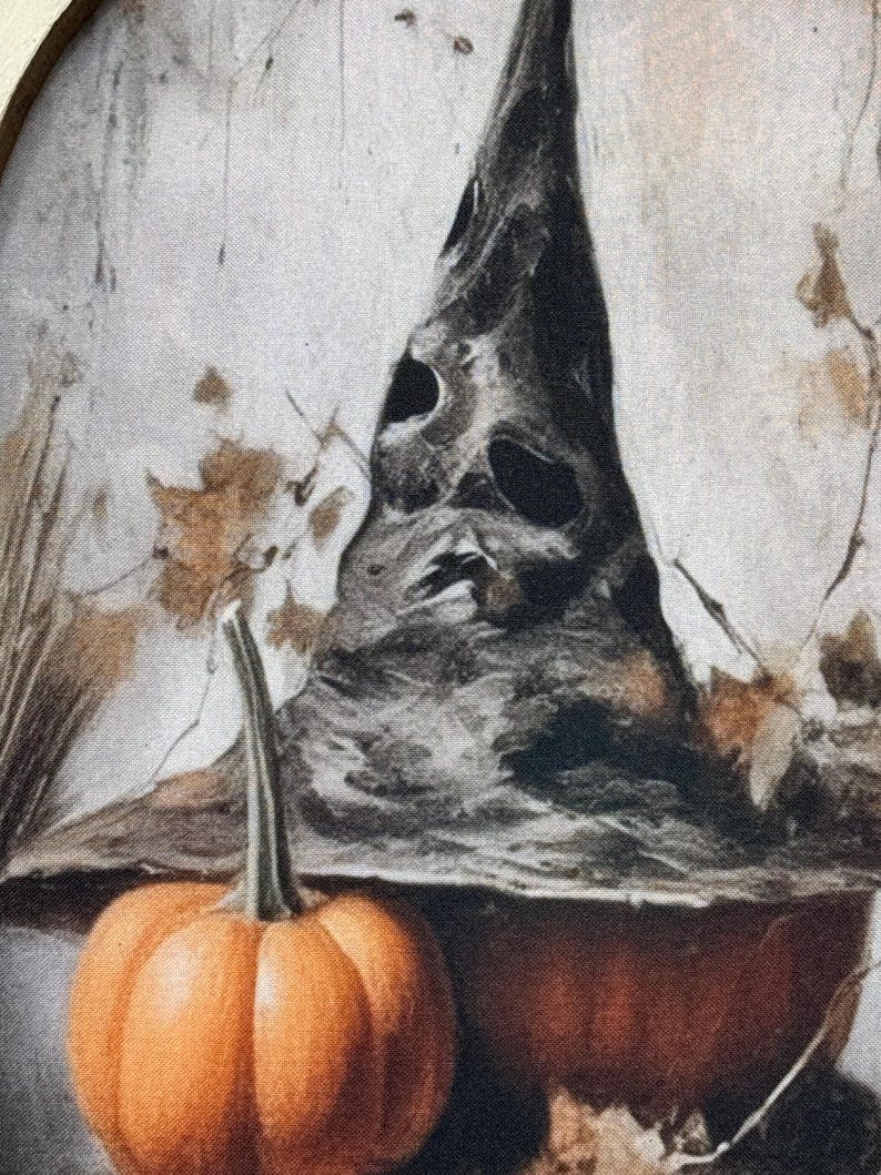May include: A witch's hat with a pointed top and a textured surface sits on top of a large orange pumpkin. A smaller orange pumpkin sits in front of the hat.