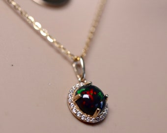 Layered necklace in 14k gold made with a natural black opal pendant with a solid gold charm necklace in two strand design/dainty chain 14k