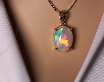 Natural Large Ethiopian Opal Necklace handmade with a genuine fire opal oval pendant in 14k gold with a solid gold chain. 14k rose gold opal