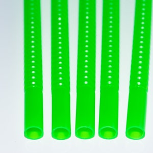 May include: Five green plastic drinking straws with a textured surface. The straws are lined up in a row.