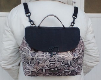 Designer vegan handbag with convertible flap, modular shoulder strap in black cork crocodile and white snake print