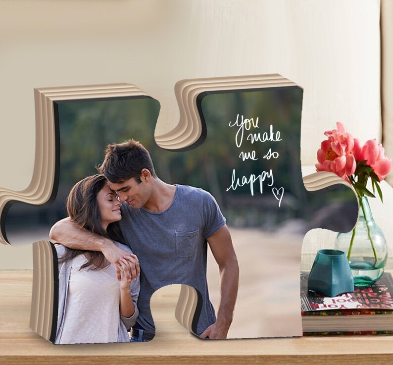 May include: A wooden puzzle piece shaped like a heart with a photo of a couple on a beach. The text "You make me so happy" is written on the puzzle piece.