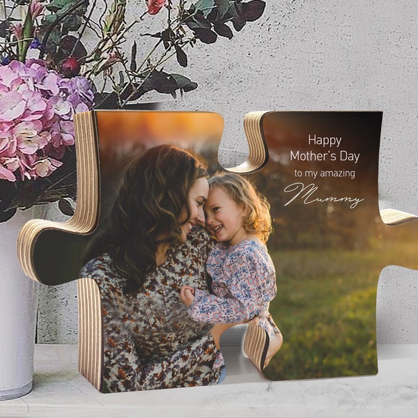 May include: A wooden puzzle shaped like two interlocking puzzle pieces with a photo of a mother and daughter printed on them. The text "Happy Mother's Day to my amazing Mummy" is printed on the right puzzle piece.