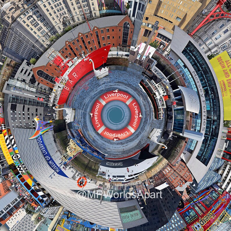 May include: A 360-degree panoramic view of the Liverpool waterfront, featuring a red ship, a life ring with the word "Liverpool" printed on it, and the Mersey Ferries building with the text "Mersey Ferries" and "All Begin and End Liverpool" printed on it.