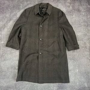May include: A dark brown and black houndstooth patterned overcoat featuring a classic collar, three front buttons, and two side pockets. The coat has long sleeves with folded cuffs and a visible interior label reading Crossland and Seven Seas.