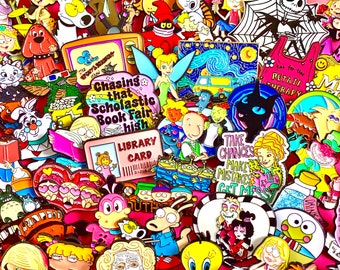 May include: A collection of colorful enamel pins featuring cartoon characters and phrases. Designs include a library card, Tinkerbell, a black cat, and the text "Chasing that Scholastic Book Fair high."