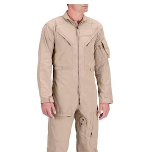 May include: A beige jumpsuit featuring a full-length zip, several pockets, and reinforced stitching. The long-sleeved jumpsuit has a tailored fit. The garment is made of a durable, lightweight fabric. Suitable for various activities.