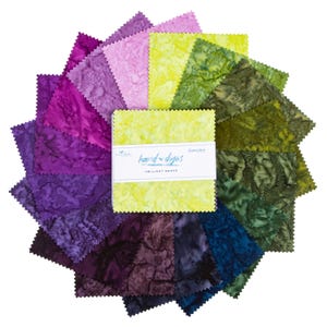 May include: A collection of fabric squares in various shades of purple, green, and yellow, arranged in a circular pattern. The squares have a textured appearance. A stack of squares is wrapped with a white label that reads "hand-dyed" and "Twilight Grove".