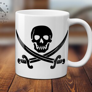 May include: White ceramic mug with a black skull and crossbones design. The skull has two eye sockets and a toothy grin. The crossbones are formed by two swords with curved blades.