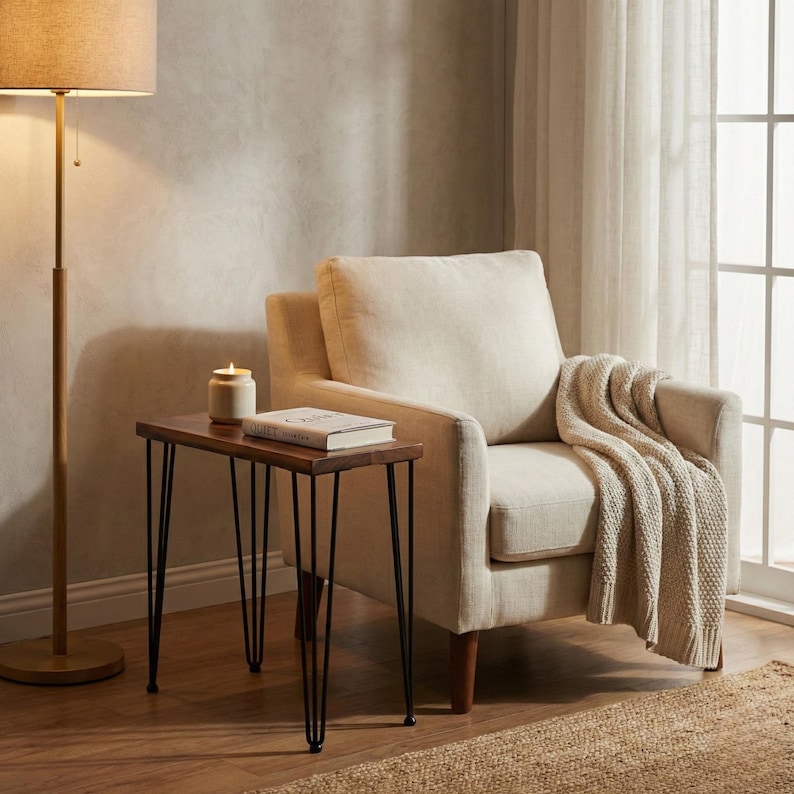 May include: A wooden side table with a dark brown walnut top and black hairpin legs. The small walnut table is made of solid wood and has a natural finish.